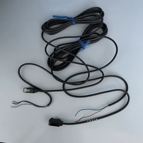 Omron E3T-ST11 2M ultra-thin through-beam photoelectric sensor pair in the shipping carton with the type label visible