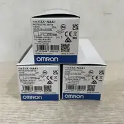 Omron E3X-NA41 2M fiber amplifier — front face with 8-turn sensitivity potentiometer and orange stability LED