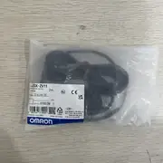 Omron E3X-ZV11 1-channel fiber amplifier — side view showing the operation indicator LED (orange), stability indicator LED (green), and the SET / mode buttons on the side face