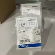 Omron E3Z-B86 clear-bottle photoelectric sensor — front view showing the red LED lens, the operation indicator, and the M8 4-pin connector at the back