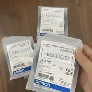Hand holding a sealed Omron E3Z-D62 anti-static bag close-up, with the TYPE E3Z-D62 label, voltage rating, and OMRON brand clearly visible