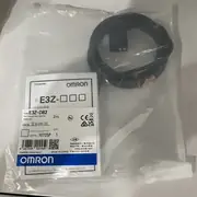 Omron E3Z-D82 diffuse-reflective photoelectric sensor — rear view showing the M8 4-pin male connector with the IEC 60947-5-2 pinout (pin 1 +V brown, pin 4 OUTPUT black, pin 3 0 V blue, pin 2 unused white) and the single-turn sensitivity trimmer