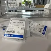 E3Z-D86 sensors in sealed anti-static bags on a shelf, with the type label and Omron branding visible