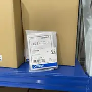 E3Z-D86 sensors in sealed anti-static bags with the type label, lot number, and voltage rating visible
