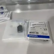 E3Z-D86 in its anti-static bag with the instruction manual, showing the compact sensor body