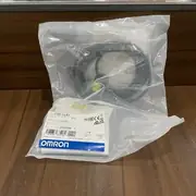 Omron E3Z-LL61 BGS laser photoelectric sensor — rear view showing the 6-turn sensitivity trimmer and the Light-ON / Dark-ON operation mode selector switch on the rear face, with the pre-wired 2 m PVC cable exiting