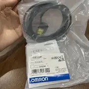 Omron E3Z-LL61 BGS laser photoelectric sensor — side view showing the 20 × 11 × 31 mm slim body with the laser warning label (Class 1) visible on the side