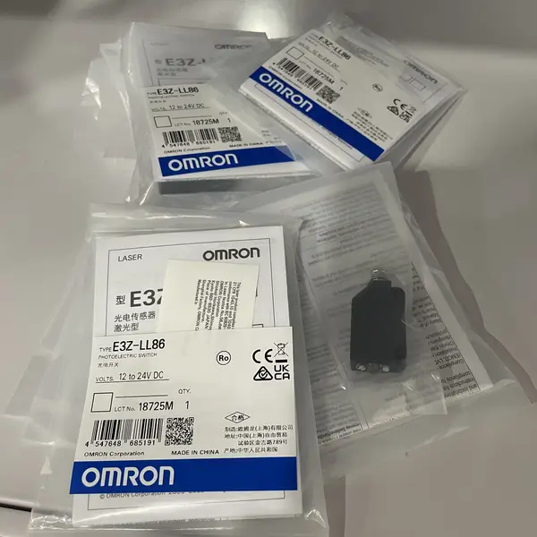 Omron E3Z-LL86 — front view of the compact ABS housing showing the red laser emitter window, the receiver lens, and the four-pin M8 connector on the rear face