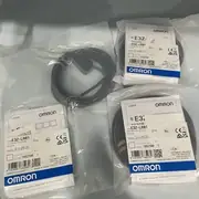 Omron E3Z-LR81 — front face of the compact PBT housing showing the laser emitter window, the receiver lens, and the indicator LEDs