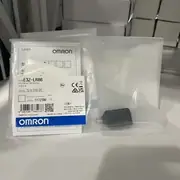 Omron E3Z-LR86 — front view of the compact PBT housing showing the red Class 1 laser emitter window, the receiver lens, and the M8 4-pin connector on the rear
