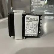 Omron E5CC-QX2ASM-802 — rear face showing the screw terminal block with the AC100-240 V supply inputs, the voltage SSR-drive output, the two auxiliary outputs, the RS-485 A/B block, and the single event input