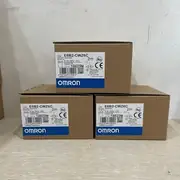 Omron E6B2-CWZ6C — top label close-up showing the part number, the 2000 P/R resolution, the DC5-24 V rating, and the NPN open-collector output marking on the housing