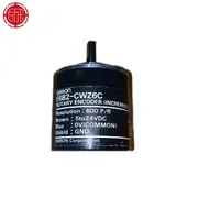 Omron E6B2-CWZ6C installed on a conveyor tail pulley with a flexible coupling to the driven shaft and a shielded cable trailing to a CJ1W-CT021 high-speed counter