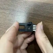 Omron EE-SX672 slot sensor — held in hand with EE-SX672 model marking visible on the side and the 5 mm slot opening facing the camera