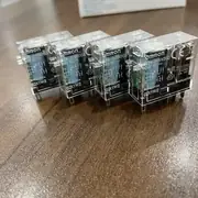 Omron G2R-2-SND DC24V DPDT 8-pin plug-in relay — bottom view showing the 8 male pins mating with a P2RF-08-E Push-In Plus socket base and the spring-clip retention notch on the rear