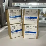 Omron G2RV-ST500 DC24 slim relay — four retail boxes on warehouse shelving showing consistent Omron labeling, QTY 10 packing, and OMRON Corporation branding across multiple lots