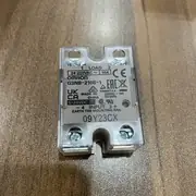 G3NB-210B-1 base plate showing the DIN-rail clip for TR35-15Fe mounting and the two M4 panel-mount screw holes