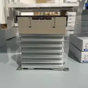 Omron G3PE-225B DC12-24V solid state relay — front view showing the compact 22.5 × 100 × 100 mm body with the integrated heat sink fins, the red LED input indicator, and the screw terminal covers for input and output wiring