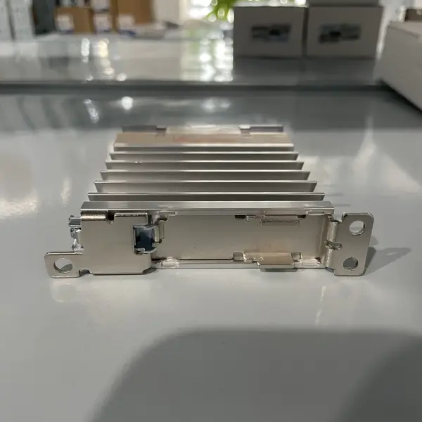 Omron G3PE-225BL DC12-24V 25 A solid-state relay - front view showing the slim 22.5 mm wide integrated heat sink, the screw terminals (M4 for AC load T1/T2 + M3.5 for DC control +/-), and the yellow LED indicator on the top face