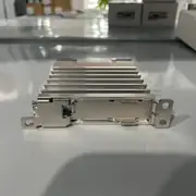 Omron G3PE-225BL DC12-24V 25 A solid-state relay - front view showing the slim 22.5 mm wide integrated heat sink, the screw terminals (M4 for AC load T1/T2 + M3.5 for DC control +/-), and the yellow LED indicator on the top face
