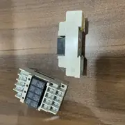 Omron G6B-4BND DC24V terminal relay — top-down view of one complete G6B-4 terminal relay block with 4 G6B mini-relays (black housings) plugged into the grey P6B socket base showing the 8 input screw terminals on the left and 8 output screw terminals on the right