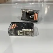 Omron G7SA-2A2B DC24 safety relay — another angle of two transparent G7SA relays showing OMRON G7SA-2A2B 24VDC MADE IN JAPAN labels and 10A 250V~6A contact rating markings on the side