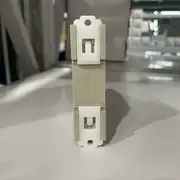 Omron H3DK-M2 AC-DC24-240V multi-function timer — side view showing the spring-clip DIN-rail retention on the rear and the DPDT / SPDT+SPDT slide-switch on the side for output contact configuration selection