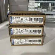 Omron H3DK-M2 AC-DC24-240V multi-function timer — installed on a 35 mm DIN rail in a control cabinet next to an H3DK-S2 4-mode timer and an H3DS-ML slim timer, with the DPDT output contacts wired to a motor contactor and a status indicator