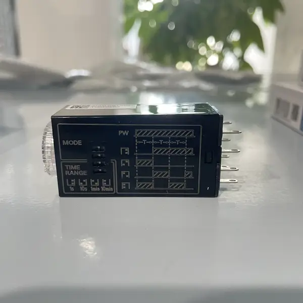 Omron H3YN-2-B DC24 solid-state timer -- 8-pin plug-in timer block with green POWER LED and red OUTPUT LED on the front face, DIP switch bank visible on the side.