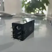 Omron H3YN-2-B DC24 solid-state timer -- side view showing the four-position DIP switch for mode selection and time cap (1 s / 10 s / 1 min / 10 min).