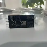 Omron H3YN-2-B DC24 solid-state timer -- plugged into a PYF-08-PU-L Push-In Plus terminal socket on a 35 mm DIN rail, powering a downstream contactor.