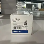 Omron H7CC-AU installed in a 45×45 mm panel cutout beside a prox sensor, wired to count parts on a conveyor and drop a relay at the preset batch quantity