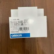 Omron K8DS-PM2 — front view of the 17.5 mm DIN-rail housing showing the green PWR LED, the yellow RY LED, the rotary voltage-selector switch for 380/400/415/480 VAC, and the marking