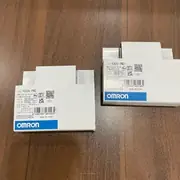 Omron K8DS-PM2 installed on a DIN rail next to a 400 V motor contactor with the three phases landed on the input terminals and the SPDT contact wired into the contactor holding circuit
