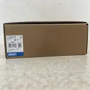Omron NB10W-TW01B HMI — rear view of the shipping box showing the Omron label close-up with TYPE NB10W-TW01B, KCC-REM-OMR-NB-00007, KC certification mark, LOT 05924M, 3KG shipping weight, OMRON Corporation, MADE IN CHINA, OMRON blue band