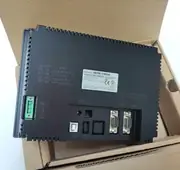 Omron NB7W-TW00B — black plastic HMI rear face showing 24V DC spring terminal, SW1 / SW2 DIP switches (System Setting / Calibrate / Downloader / User Project), MODE switch, COM1 and COM2 DB-9 connectors, USB-B slave port, USB-A host port, and 10/100 BASE-TX Ethernet port