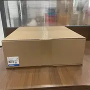 Omron NS12-TS01-V2 NS-series HMI — retail cardboard box with Omron type label (TYPE NS12-TS01-V2), OMRON Corporation origin mark, made in Japan, Lot 29Z22K