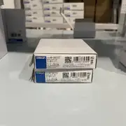 Omron NX-DA2203 2-channel analog current output module — front view showing the 8-position screwless push-in terminal block, with 4 terminals per channel (OUT+, OUT-, shield, +V sense)
