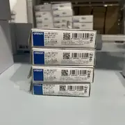 Omron NX-DA2203 NX-series 4-20 mA output slice — top view showing the TS (Trouble Status) indicator LED and per-channel output activity LEDs, with the model-number label centered on the top edge