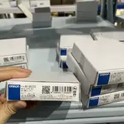 Omron NX-DA2203 NX-series 2-point current output mounted on a slice rail behind an NX-ECC201 EtherCAT coupler — wired to a Danfoss VFD speed-reference input (4-20 mA) and a pneumatic valve positioner on a process skid