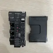 Omron NX-ECC201 EtherCAT coupler — unit placed next to the end cover on table showing the right-side NX bus connector without end cover attached