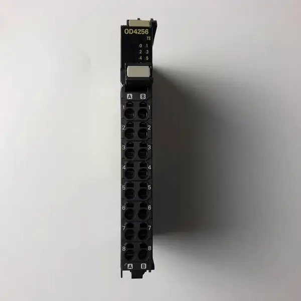 Omron NX-OD4256 8-point PNP output unit — front view showing the compact 12 mm wide body with 8 yellow output status LEDs across the front face and the screwless push-in 16-terminal connector on the bottom