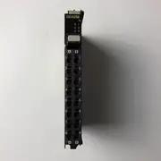 Omron NX-OD4256 8-point PNP output unit — front view showing the compact 12 mm wide body with 8 yellow output status LEDs across the front face and the screwless push-in 16-terminal connector on the bottom