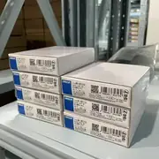 Omron NX-OD5256 NX-series 16-pt output unit — top view showing the model-number label with 'NX-OD5256' designation and the COM terminal arrangement (2 commons × 8 outputs each)
