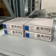 Omron NX-OD5256 mounted on a slice rail behind an NX-ECC202 EtherCAT coupler — driving 16 pneumatic solenoid valves on an assembly-machine pneumatic manifold with the LED indicators visible at the top of each terminal block pair