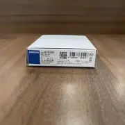Omron NX-PD1000 NX unit power supply — 12 mm wide NX-series module with the orange locking slider visible on the right side, screwless push-in terminal block on top with 8 terminals (IOV/V+, IOG/V−, FG pairs)