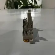 P7SA-10F-ND socket viewed from the terminal side showing the four M3 wiring screws along the coil and contact rows, the yellow / orange release lever at the bottom, and the Omron P7SA-10F-ND DC24V face label