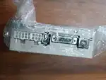 Omron R7D-BP02HH-Z — drive wrapped in its clear anti-static bag on a wooden surface, showing the R7D-BP02HH-Z 200V label and terminal blocks through the plastic