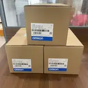 Omron R88M-1M75030H-S2 servo motor — three brown cardboard shipping boxes with Omron labels showing TYPE R88M-1M75030H-S2, AC SERVO MOTOR, QTY 1, MADE IN THE PHILIPPINES, with serial numbers 03251701154P / 03251701219P / 03251701241P