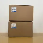 Omron R88M-K2K030H-S2-Z servo motor — two sealed cardboard shipping boxes stacked showing Omron type labels with R88M-K2K030H-S2-Z / AC SERVO MOTOR markings